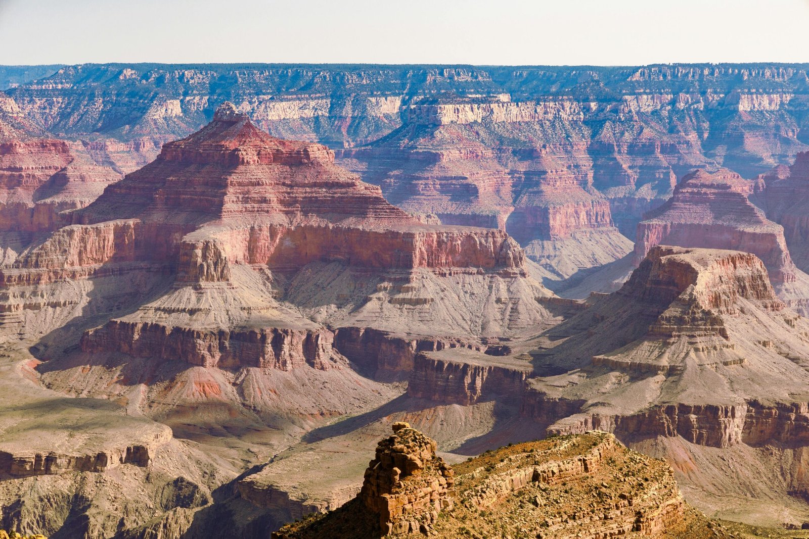 Stunning view of Grand Canyon's layered rock formations and vivid colors under a clear sky.